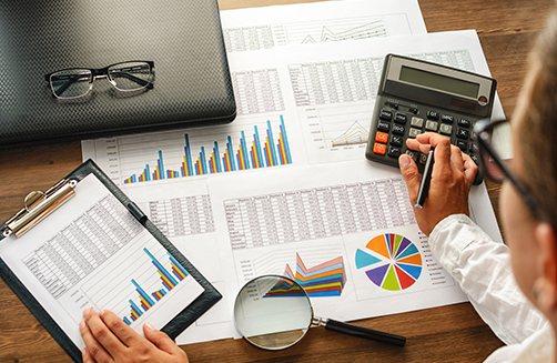 Financial paper charts and graphs on the table. Financial paper charts and graphs on the table.