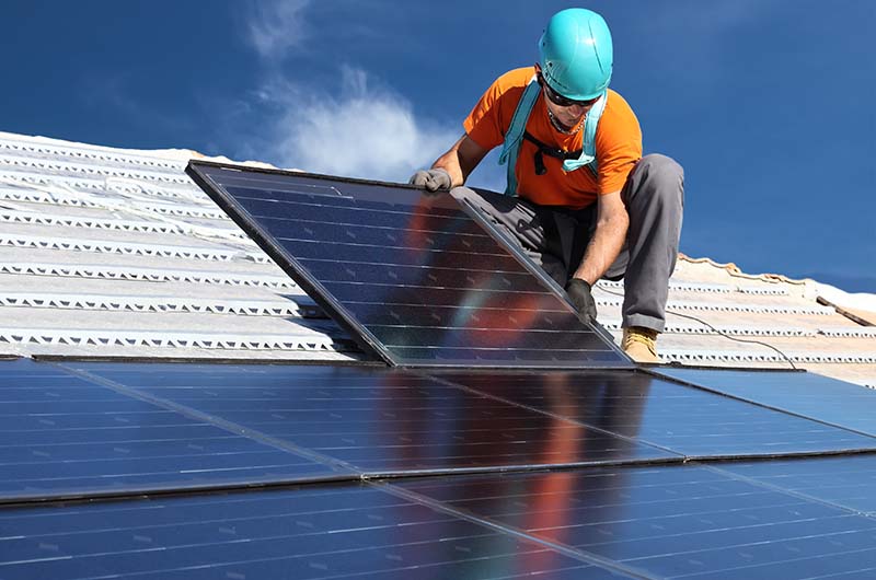 installing alternative energy photovoltaic solar panels on roof1_Web.jpg